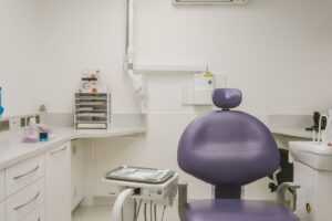 Clean and modern dental treatment room with a purple dental chair at Lodge Causeway Dental Centre in Bristol
