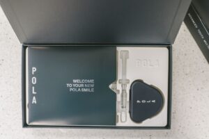 Open Pola professional teeth-whitening kit containing whitening gel and a custom dental tray case