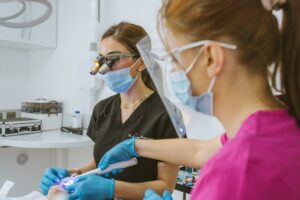 Dentist and dental nurse working together during a composite bonding procedure in a modern Bristol dental surgery
