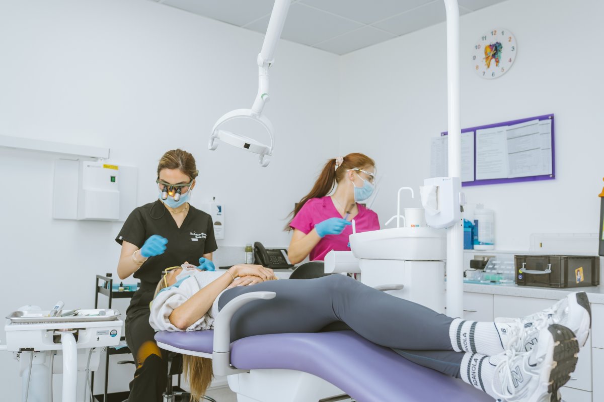 Dentist and dental nurse carrying out composite bonding treatment for a patient at Lodge Causeway Dental Centre in Bristol