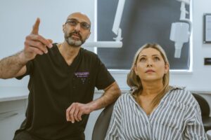 Dentist assessing a patient and discussing the next steps of her dental implant treatment in a Bristol clinic