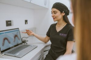 Invisalign dentist explaining a digital 3D model of the patient’s teeth during a smile assessment in Bristol