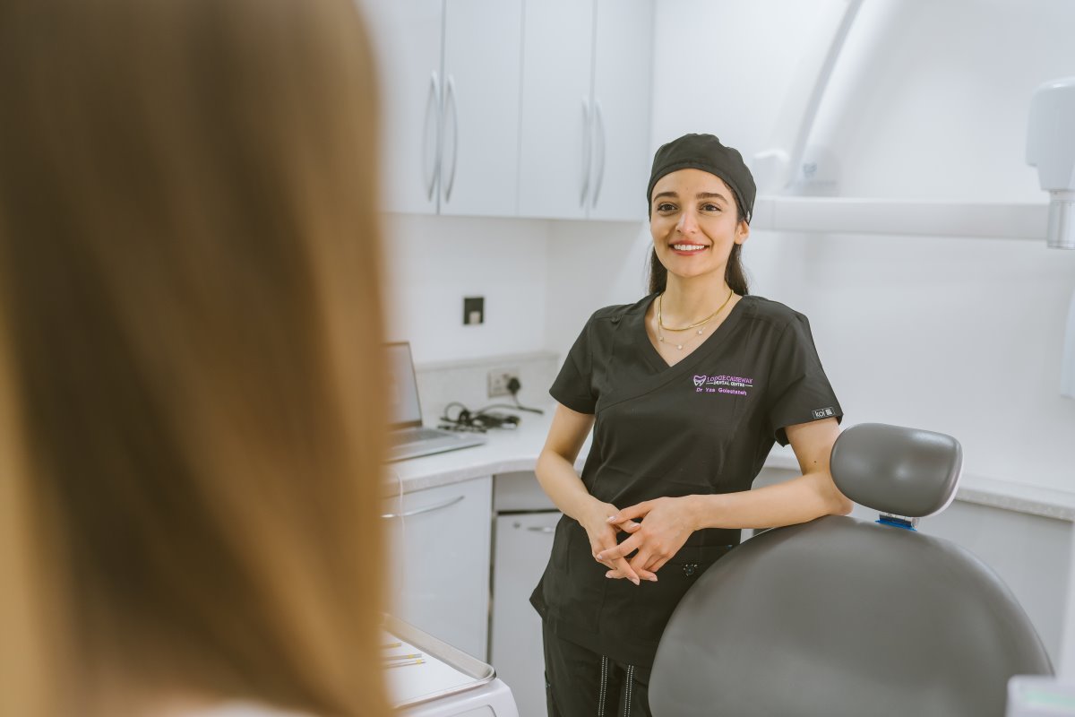 Invisalign dentist speaking with a patient during an initial clear aligner consultation at Lodge Causeway Dental Centre in Bristol