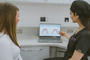 Patient reviewing a digital Invisalign treatment simulation with her dentist at Lodge Causeway Dental Centre
